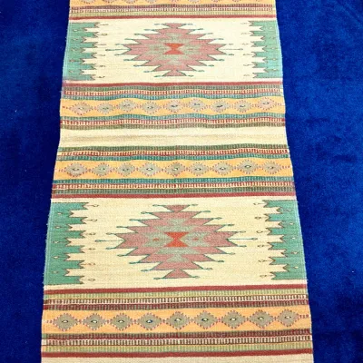 Sale Photo Thumbnail #419: Handwoven Southwestern or Native American style wool runner rug featuring geometric diamond patterns and fringed ends in muted earth tones.