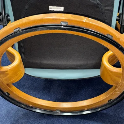 Sale Photo Thumbnail #235: Underside mechanism and wooden ring swivel base of a Stressless Scandinavian style armchair.