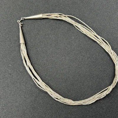 Sale Photo Thumbnail #180: Multi-strand sterling silver liquid silver necklace with cones and hook-and-eye closure.