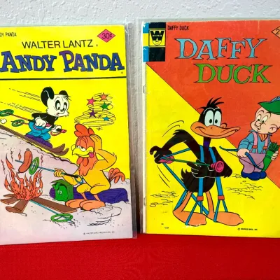 Sale Photo Thumbnail #812: Pair of vintage Whitman comic books featuring Walter Lantz's Andy Panda and Warner Bros. Daffy Duck, both individually bagged for protection.