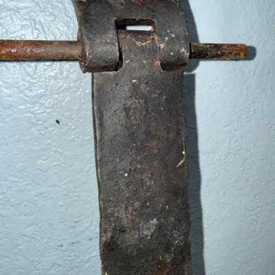 Sale Photo Thumbnail #645: Antique hand-forged wrought iron strap hinge section displaying heavy patina and surface rust.