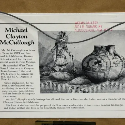 Sale Photo Thumbnail #489: Artist biography label on the reverse of a framed artwork by Michael Clayton McCullough.