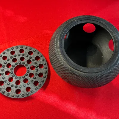 Sale Photo Thumbnail #468: Black cast iron Japanese-style hobnail incense burner or tea light warmer base with removable perforated lid, resting on a red fabric surface.