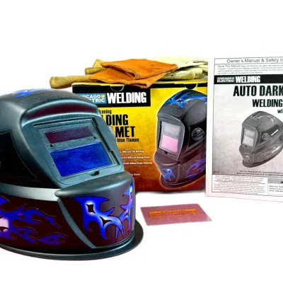 Sale Photo Thumbnail #42: Chicago Electric auto-darkening welding helmet with blue flame graphics, featuring its original box, owner's manual, and a pair of leather welding gloves.