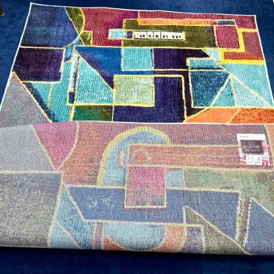 Sale Photo Thumbnail #730: Modern abstract geometric area rug with vibrant jewel-toned blocks and a woven backing.