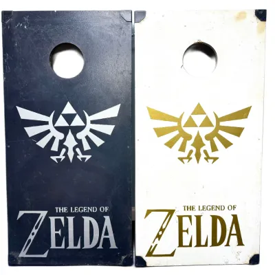 Sale Photo Thumbnail #99: Pair of custom-themed cornhole boards featuring The Legend of Zelda logo graphics in black and white.