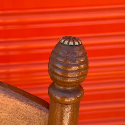 Sale Photo Thumbnail #707: Close-up detail of a wooden bedpost finial featuring carved beehive rings and a small metal top cap.