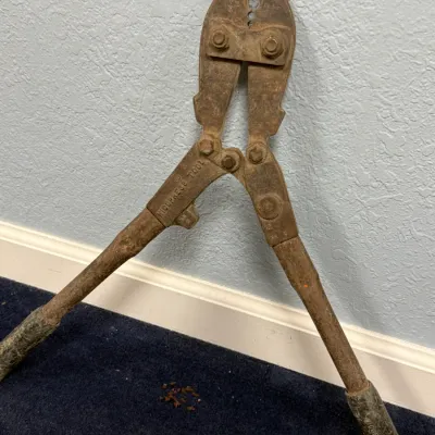 Sale Photo Thumbnail #571: Vintage heavy-duty Nicopress swaging tool with textured rubber handle grips, showing surface rust from use.
