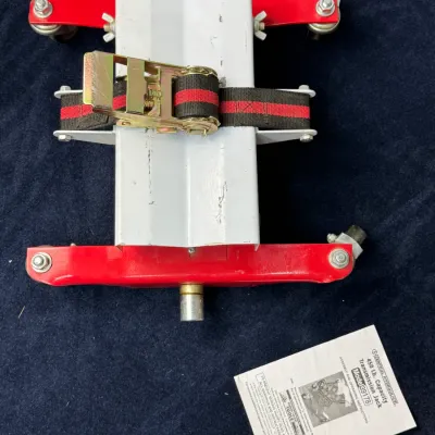Sale Photo Thumbnail #531: Central Hydraulics 450 lb. capacity transmission jack attachment, Model 39178, featuring swivel casters, a securing ratchet strap, and original instruction manual.