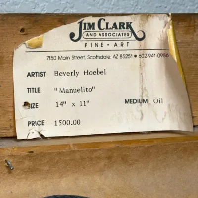 Sale Photo Thumbnail #145: Gallery label on the reverse of a frame for an oil painting titled "Manuelito" by Beverly Hoebel.