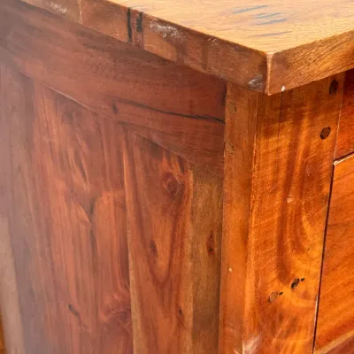 Sale Photo Thumbnail #250: Close-up detail of a rustic solid wood cabinet featuring prominent grain patterns and visible joinery with light edge wear.