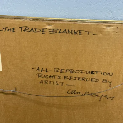 Sale Photo Thumbnail #116: Backing of a framed artwork titled "The Trade Blanket", featuring handwritten artist copyright text signed by Wm. Moyers.