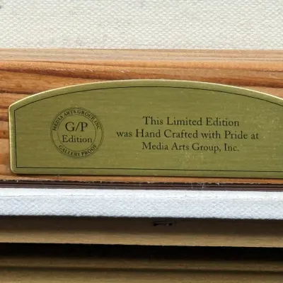 Sale Photo Thumbnail #835: Brass plaque on a picture frame identifying a limited edition G/P Edition Gallery Proof crafted by Media Arts Group, Inc.