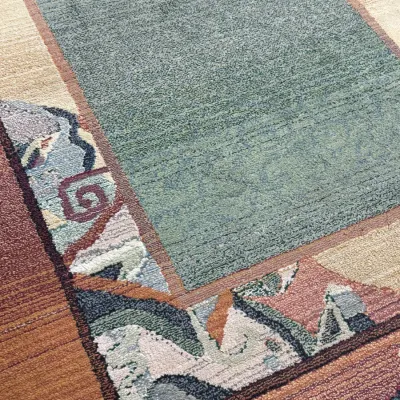 Sale Photo Thumbnail #711: Contemporary wool area rug featuring a sage green central field bordered by geometric and abstract motifs in terracotta, cream, and lavender tones.