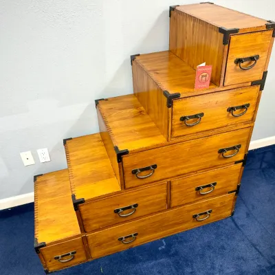 Sale Photo Thumbnail #202: Japanese step chest, or kaidan tansu, featuring multiple drawers with metal bracket hardware and loop pulls.