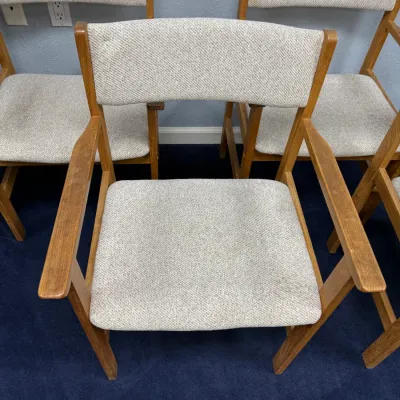 Sale Photo Thumbnail #692: Set of mid-century style wooden armchairs with light gray tweed-like upholstered seats and backs.