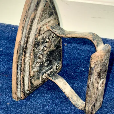 Sale Photo Thumbnail #597: Antique cast iron sad iron, size No. 6, featuring heavy surface patina and wear consistent with age.
