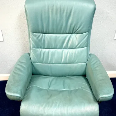 Sale Photo Thumbnail #224: Ekornes Stressless reclining armchair upholstered in light aqua or seafoam green leather with a bentwood swivel base, showing light surface wear.