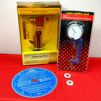 Sale Photo Thumbnail #44: Selection of specialty tools including a boxed Protocol HammerPlus multi-tool, an Engine Building Tools rod bolt stretch gauge in blister packaging, and a blue degree wheel with washers.