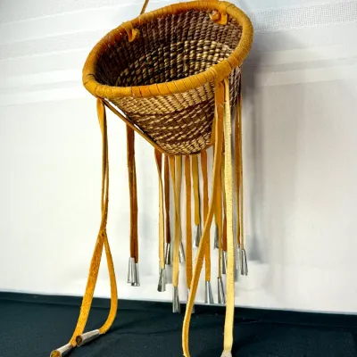 Sale Photo Thumbnail #402: Native American style woven cone basket planter featuring a wrapped leather rim, hanging strap, and dangling suede tassels with tin tin jingles.