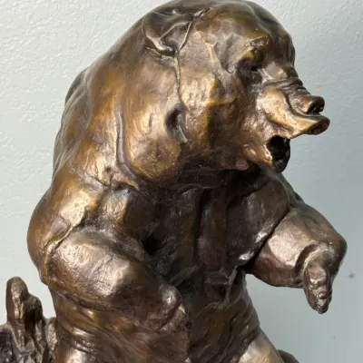 Sale Photo Thumbnail #126: Cast bronze sculpture of a snarling grizzly bear with a warm brown patina.
