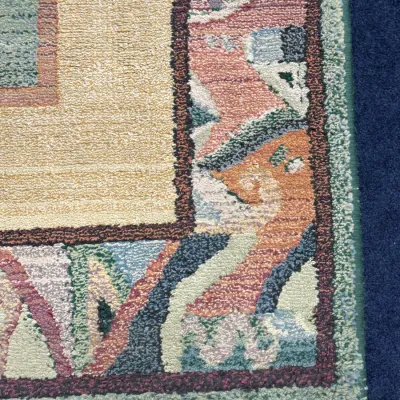 Sale Photo Thumbnail #710: Detail view of a thick-pile area rug featuring a colorful patterned border in pastel tones of sage, terracotta, mauve, and cream.