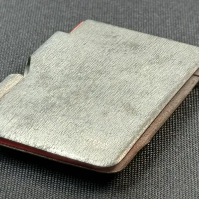 Sale Photo Thumbnail #199: Vintage brushed metal pocket notepad case with pen holder slot, marked Made in Japan.