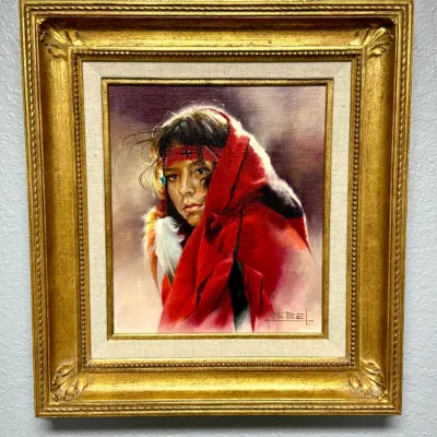 Sale Photo Thumbnail #150: Framed oil painting depicting a Native American figure wrapped in a red blanket, signed Goebel lower right. The piece is set in a fabric liner and an ornate gilt wood frame.