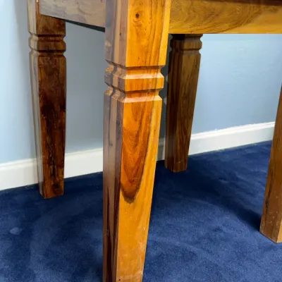 Sale Photo Thumbnail #735: Solid rosewood end table featuring natural wood grain variations and notched detail on the legs.