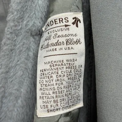 Sale Photo Thumbnail #872: Vintage Landers All Seasons Calendar Cloth garment label sewn into a grey faux fur-lined coat.