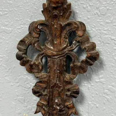 Sale Photo Thumbnail #394: Antique carved wooden wall ornament featuring intricate acanthus leaf and ribbon scroll details with a rich, dark patina.