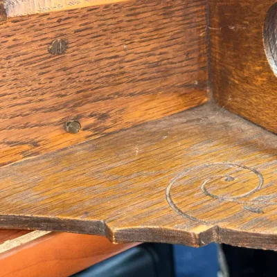 Sale Photo Thumbnail #379: Close-up detail of an antique oak shelf showing carved scrollwork and joinery.