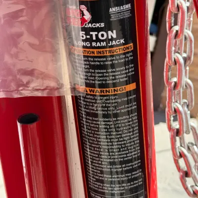 Sale Photo Thumbnail #509: Torin Big Red Jacks 5-ton long ram hydraulic jack with attached lifting chain and instruction label.