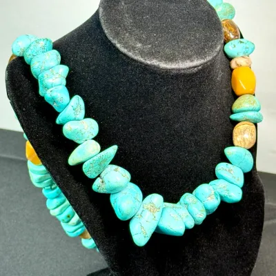 Sale Photo Thumbnail #356: Chunky turquoise and mixed gemstone nugget bead necklace displayed on a black velvet jewelry bust.
