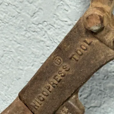 Sale Photo Thumbnail #572: Vintage Nicopress swaging tool with rusted metal patina.