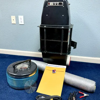 Sale Photo Thumbnail #537: American Safe Room air filtration ventilation system featuring a black blower housing, blue cylindrical filter unit, flexible ducting, power cables, and documentation.