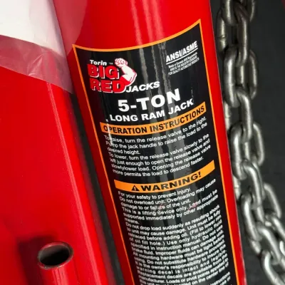 Sale Photo Thumbnail #515: Torin Big Red Jacks 8-ton long ram jack with attached chain, appearing in like-new condition.