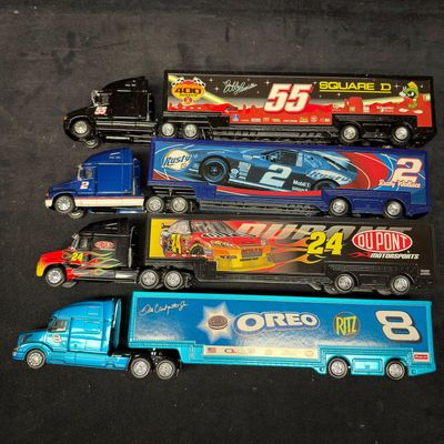Sale Photo Thumbnail #405: 4 NASCAR Die-Cast Transporter Trucks Oreo Ritz Du Pont Looney Tunes