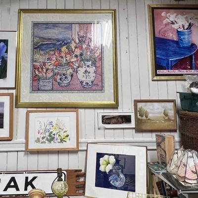 Collection of framed art prints and paintings.