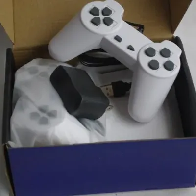 Pair of modern white USB video game controllers and power adapter, boxed and in good condition.