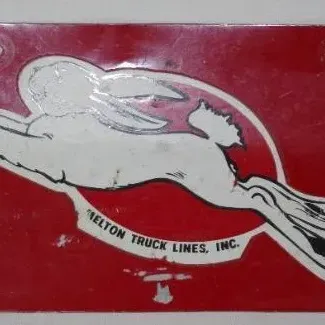 Vintage red metal license plate topper featuring a running rabbit graphic for Melton Truck Lines, Inc.