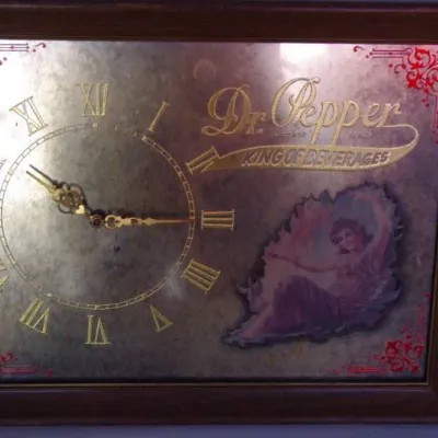 Vintage framed Dr. Pepper advertising mirror clock featuring 'King of Beverages' branding and an illustration of a woman in a...