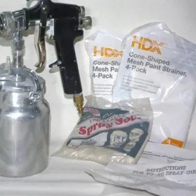 Pneumatic paint spray gun with an aluminum canister, accompanied by packages of HDX cone-shaped mesh paint strainers and spray socks.
