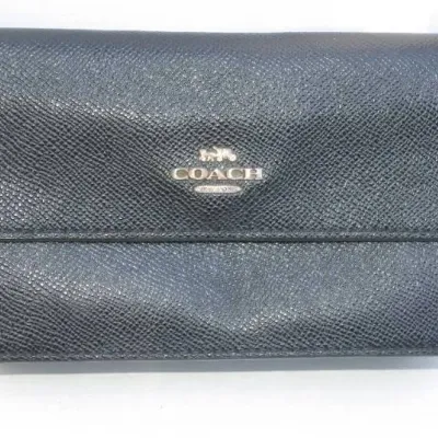 Black Coach crossgrain leather flap wallet featuring metallic silver logo lettering.
