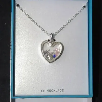 Silver-tone 18-inch chain necklace featuring a clear glass heart-shaped shaker locket pendant filled with small charms and colored...