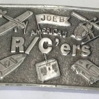 Vintage pewter metal belt buckle featuring molded relief graphics for Joe B. America's R/C'ers, depicting radio-controlled...