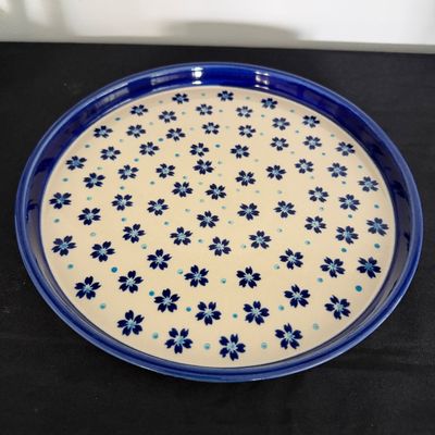 Sale Photo Thumbnail #19: Polish pottery round tray featuring a blue and light blue floral motif on a cream background with a cobalt rim.