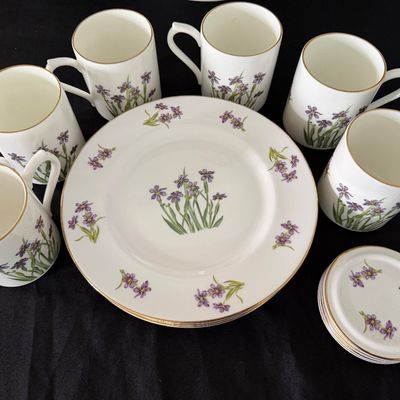 Sale Photo Thumbnail #8: Set of fine china tea mugs, dessert plates, and matching coasters featuring a purple floral motif with gold rim trim.