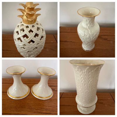 Sale Photo Thumbnail #6: Collection of cream-colored Lenox porcelain items with gold trim, including a pineapple figure, embossed vases, and a pair of candlesticks.