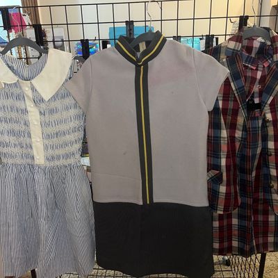 Trio of vintage women's dresses, including a blue-and-white striped dress with smocking and a peter pan collar, a mod colorblocked...